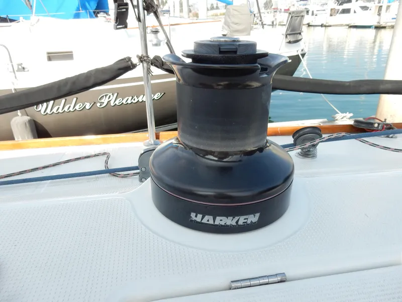 Slide: The Image of Harken winch on 2005 Beneteau First 44.7 sailboat deck, marina background. - 15