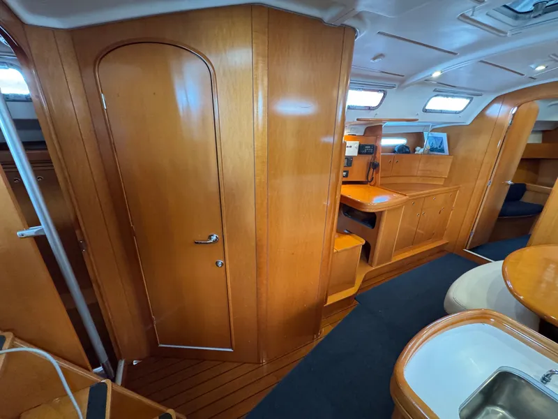 Slide: The Image of Interior of 2005 Beneteau First 44.7 yacht with wooden cabinetry and seating area. - 20