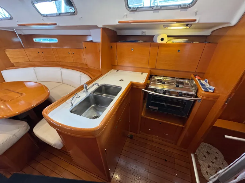 Slide: The Image of Interior of 2005 Beneteau First 44.7 yacht with kitchen and dining area. - 21