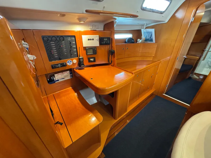 Slide: The Image of 2005 Beneteau First 44.7 yacht interior with navigation station and wooden cabinetry. - 24