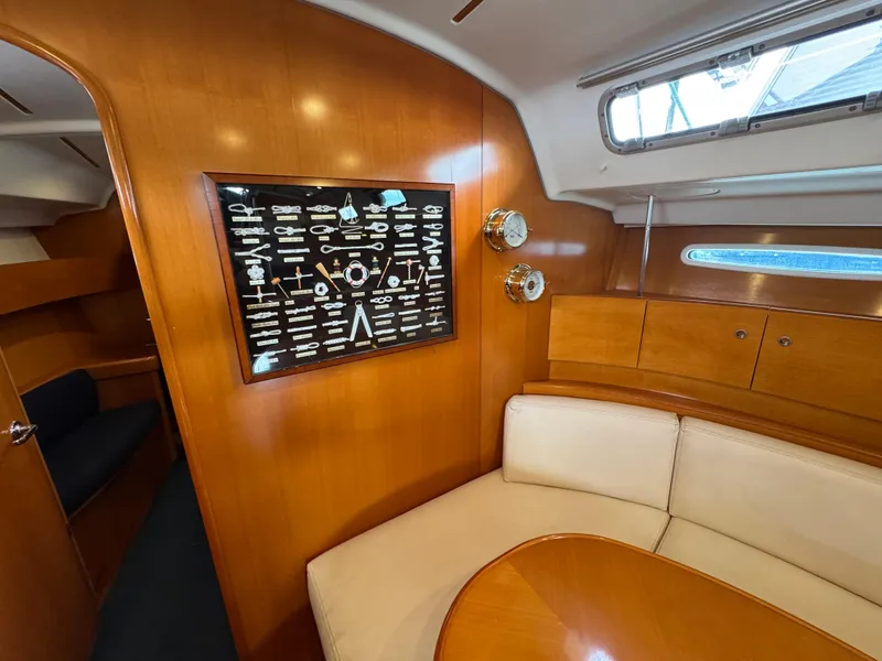 Slide: The Image of Interior of 2005 Beneteau First 44.7 yacht with wooden paneling and white seating. - 27