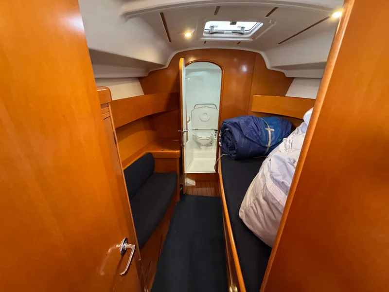 Slide: The Image of 2005 Beneteau First 44.7 cabin interior with wooden finish and cozy sleeping area. - 28