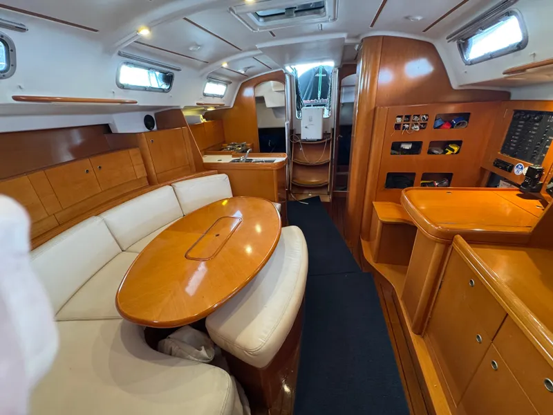 Slide: The Image of Interior of 2005 Beneteau First 44.7 yacht with wooden furnishings and white seating. - 31