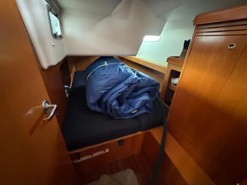 Slide: The Image of Cozy cabin interior of 2005 Beneteau First 44.7 sailboat with wooden finish and bedding. - 33