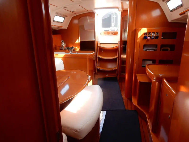 Slide: The Image of Interior of 2005 Beneteau First 44.7 yacht, featuring elegant wood finish and cozy seating. - 4