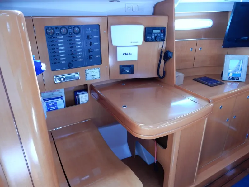 Slide: The Image of Navigation station of 2005 Beneteau First 44.7 yacht with control panel and wooden finish. - 8