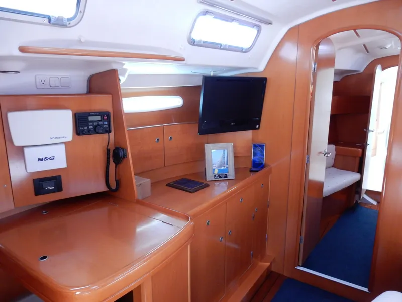 Slide: The Image of Interior of 2005 Beneteau First 44.7 yacht with wooden cabinetry and modern navigation equipment. - 9