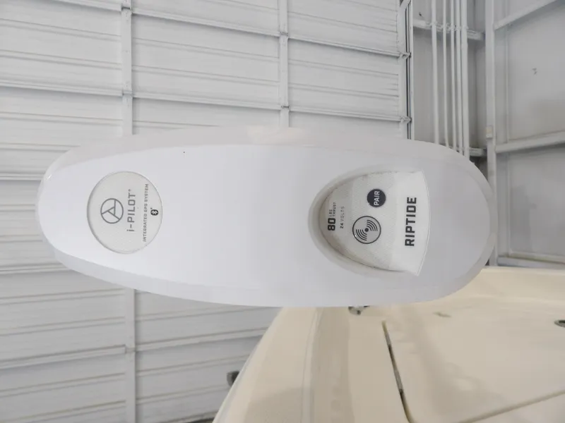 Slide: The Image of 2019 Skeeter SX210 boat with i-Pilot Riptide trolling motor in a garage. - 11