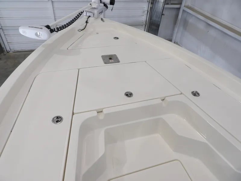 Slide: The Image of 2019 Skeeter SX210 boat deck with storage compartments and trolling motor. - 12