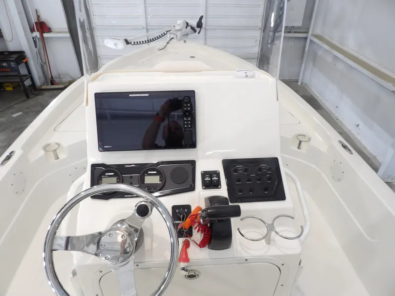 Slide: The Image of 2019 Skeeter SX210 boat console with steering wheel, controls, and navigation display. - 17