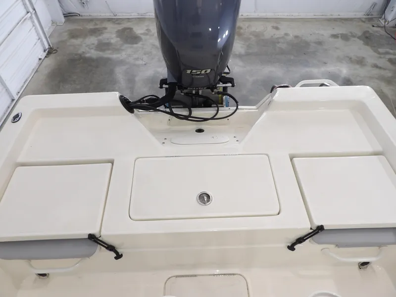 Slide: The Image of 2019 Skeeter SX210 boat with Yamaha 150 engine in a garage setting. - 22