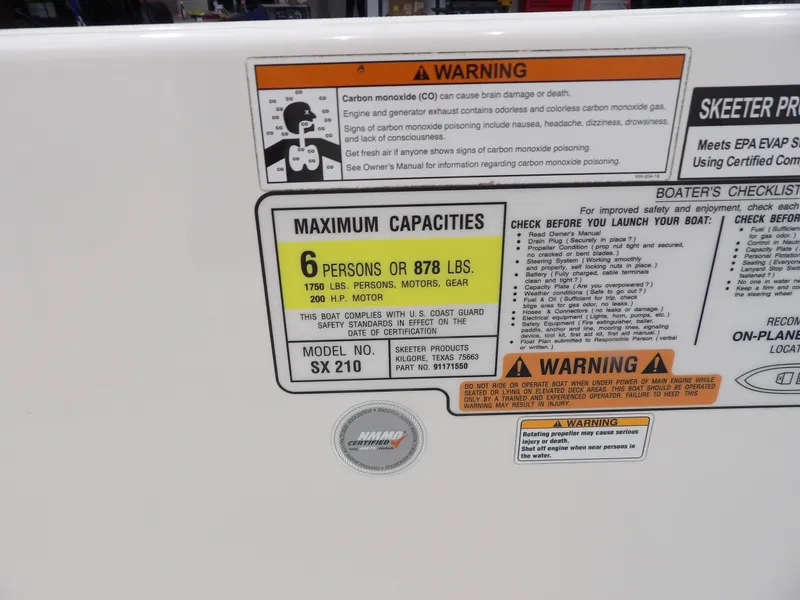 Slide: The Image of 2019 Skeeter SX210 capacity label, warning signs, and safety checklist on boat interior. - 23