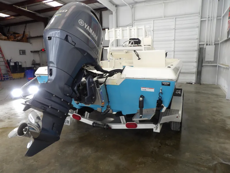 Slide: The Image of 2019 Skeeter SX210 boat with Yamaha outboard motor in a garage setting. - 9