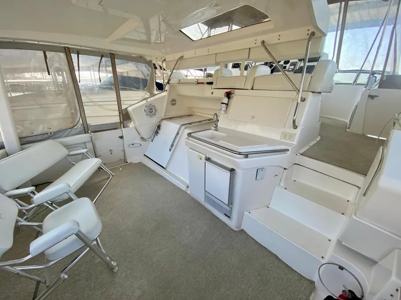 Slide: The Image of 1999 Silverton 392 Motor Yacht interior with seating, steps, and windows. - 10