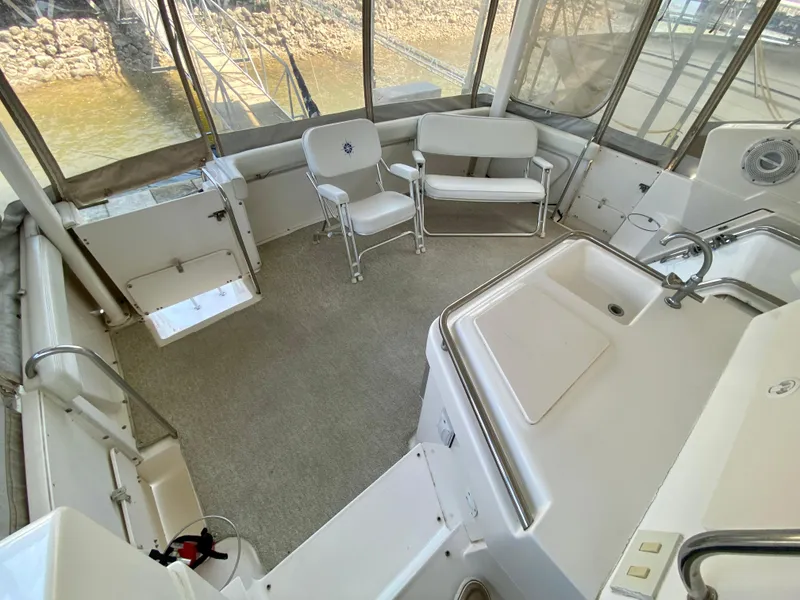 Slide: The Image of 1999 Silverton 392 Motor Yacht interior with seating and sink, featuring spacious layout. - 11