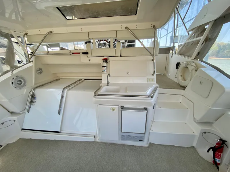 Slide: The Image of 1999 Silverton 392 Motor Yacht interior with kitchenette and seating area. - 12
