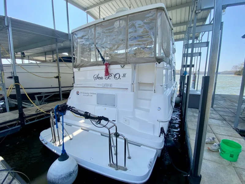 Slide: The Image of 1999 Silverton 392 Motor Yacht docked in a marina, rear view. - 2