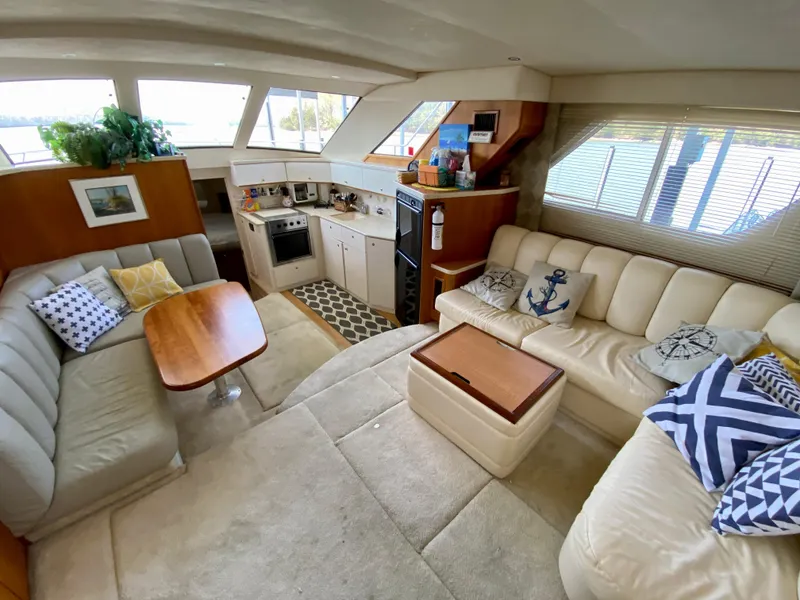 Slide: The Image of Interior of 1999 Silverton 392 Motor Yacht with cozy seating and kitchen area. - 20
