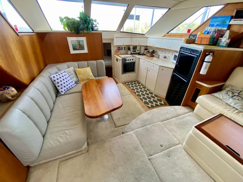 Slide: The Image of Luxurious interior of a 1999 Silverton 392 Motor Yacht with cozy seating and modern kitchen. - 22