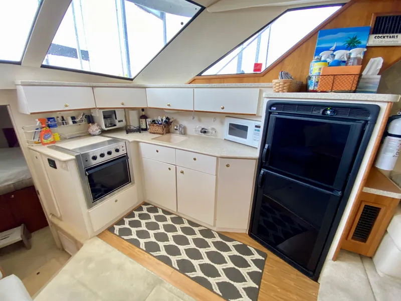 Slide: The Image of 1999 Silverton 392 Motor Yacht kitchen with modern appliances and ample storage. - 26