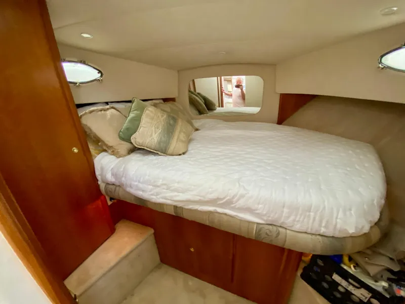 Slide: The Image of 1999 Silverton 392 Motor Yacht bedroom with cozy bed and elegant decor. - 28