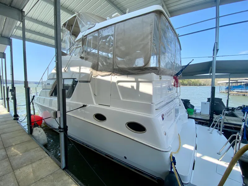 Slide: The Image of 1999 Silverton 392 Motor Yacht docked under a covered marina. - 3