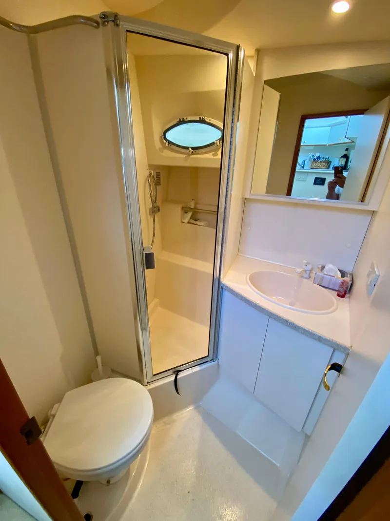 Slide: The Image of 1999 Silverton 392 Motor Yacht bathroom with shower, sink, and toilet. - 30