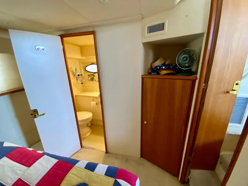 Slide: The Image of Interior of 1999 Silverton 392 Motor Yacht with bathroom and storage cabinet. - 33