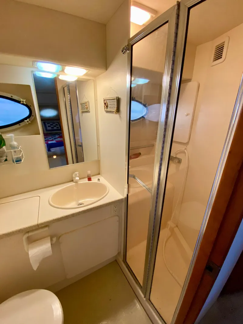 Slide: The Image of 1999 Silverton 392 Motor Yacht bathroom with shower, sink, and mirror. - 35