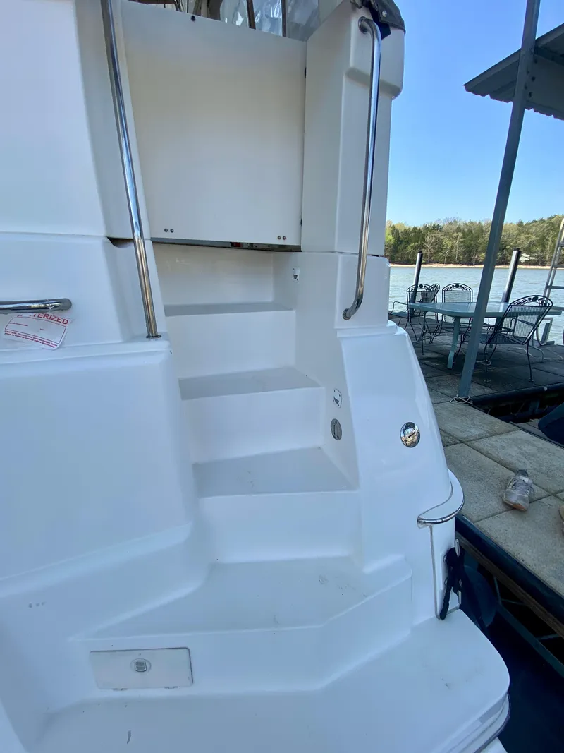 Slide: The Image of 1999 Silverton 392 Motor Yacht stairs with railing, dockside view. - 4