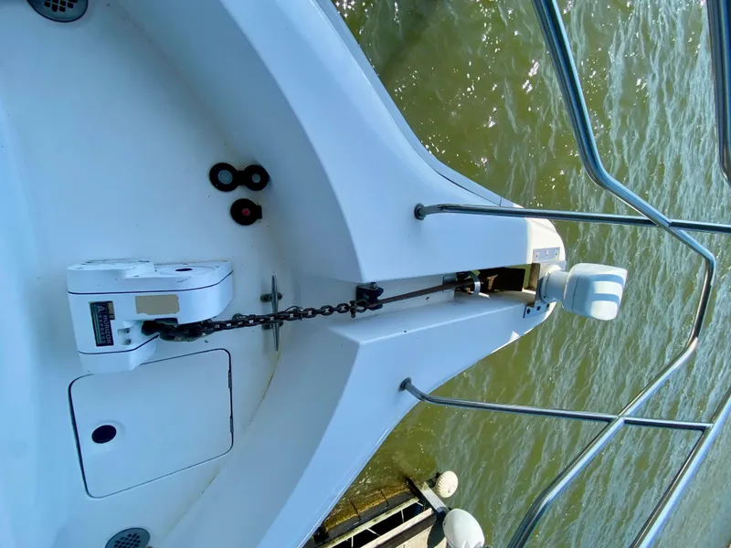 Slide: The Image of 1999 Silverton 392 Motor Yacht anchor system on deck, near water. - 7