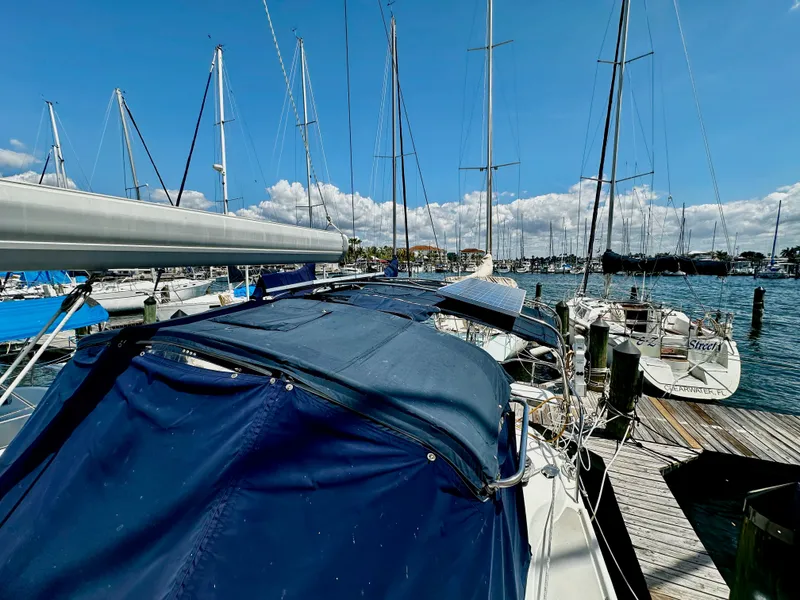 Slide: The Image of 2005 Catalina 350 sailboat docked, blue sky, calm waters. - 39
