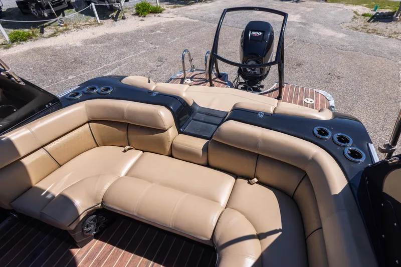 Slide: The Image of 2015 South Bay 724 SPORT DLX boat with tan seating and outboard motor. - 10