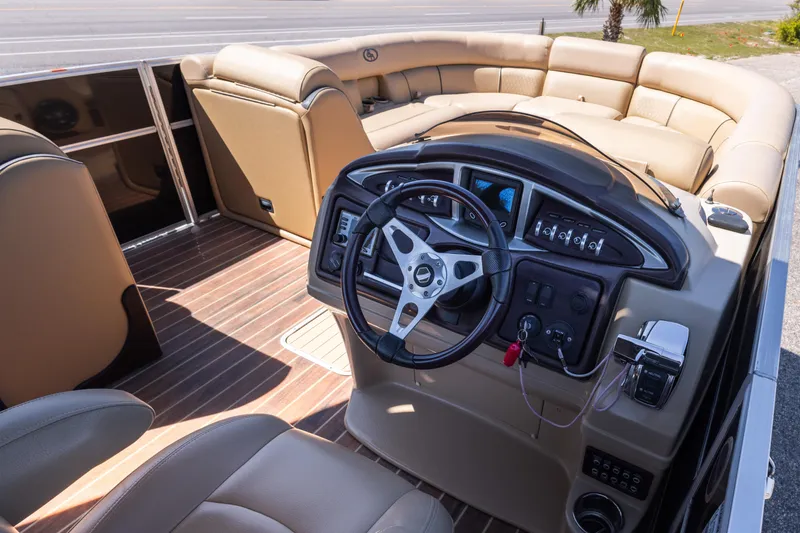 Slide: The Image of 2015 South Bay 724 SPORT DLX boat interior with beige seating and modern dashboard. - 11