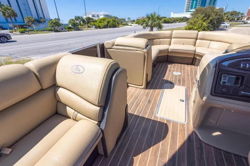 Slide: The Image of 2015 South Bay 724 SPORT DLX pontoon boat with luxurious beige seating and wood-style flooring. - 15