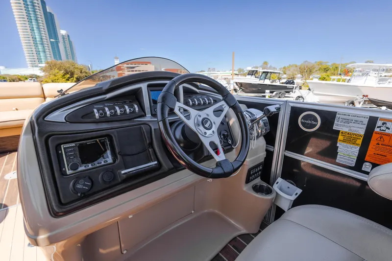 Slide: The Image of 2015 South Bay 724 SPORT DLX boat dashboard with steering wheel and control panel. - 16