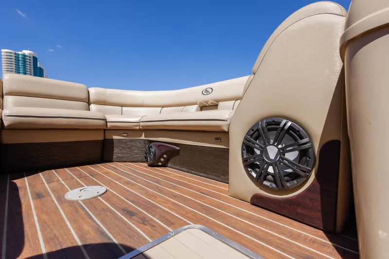 Slide: The Image of 2015 South Bay 724 SPORT DLX boat interior with tan seating and wood flooring. - 18