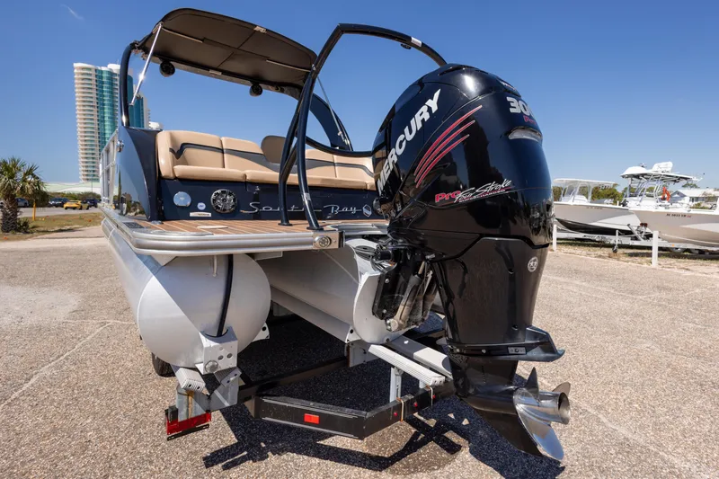 Slide: The Image of 2015 South Bay 724 SPORT DLX pontoon boat with Mercury outboard motor, parked on a trailer. - 20