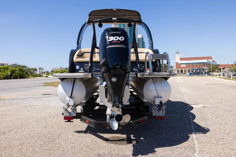 Slide: The Image of 2015 South Bay 724 SPORT DLX pontoon boat with powerful 300 HP engine, parked outdoors. - 21
