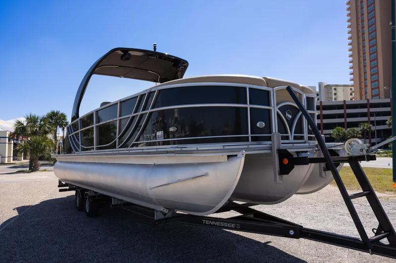 Slide: The Image of 2015 South Bay 724 SPORT DLX pontoon boat on trailer, parked outdoors. - 3