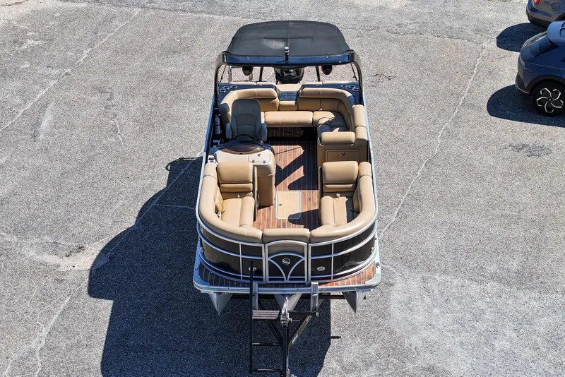 Slide: The Image of 2015 South Bay 724 SPORT DLX pontoon boat with tan seating and black canopy. - 4