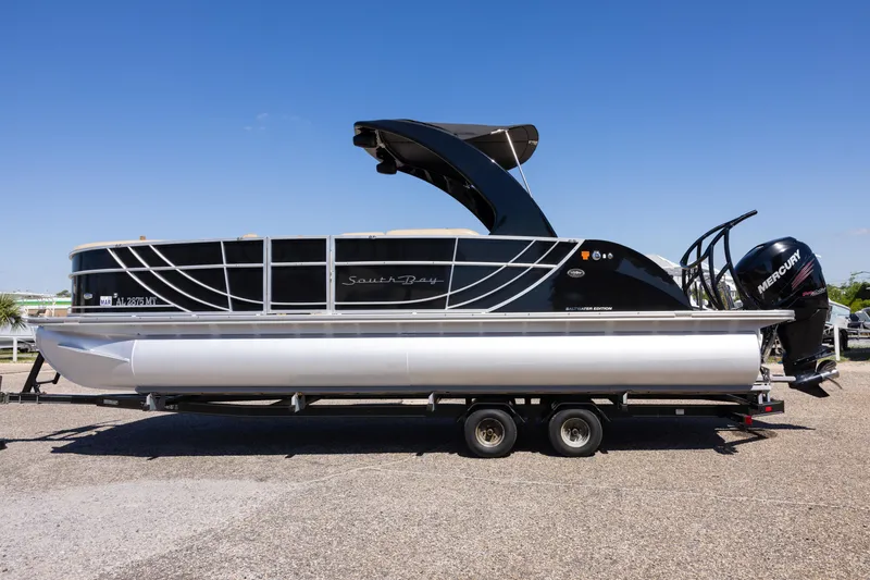 Slide: The Image of 2015 South Bay 724 SPORT DLX pontoon boat on trailer, featuring sleek black design. - 6