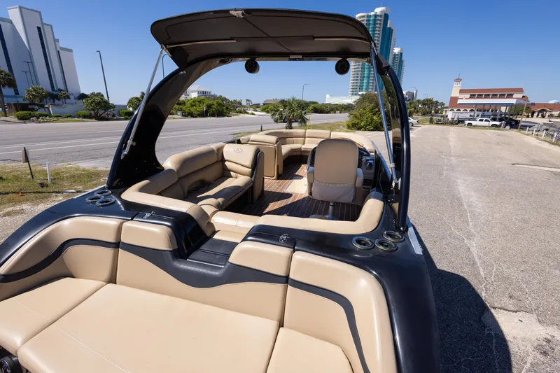 Slide: The Image of 2015 South Bay 724 SPORT DLX boat with luxurious seating and sleek design, parked outdoors. - 8