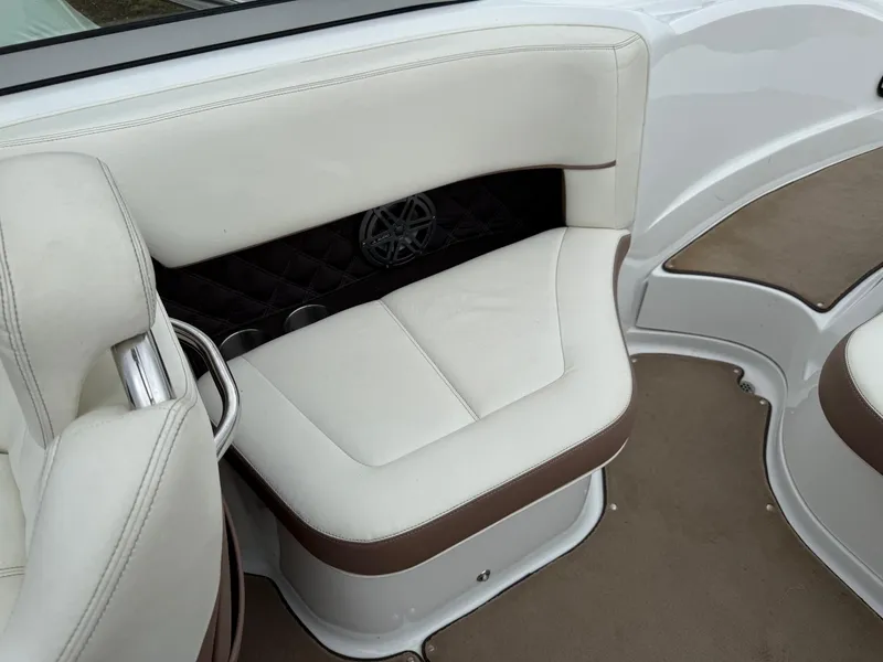 Slide: The Image of Luxurious seating in a 2013 Cobalt 242 boat with white and brown upholstery. - 17