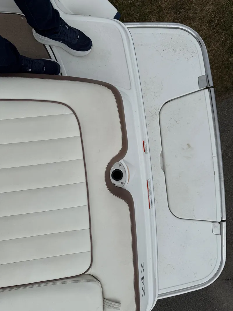 Slide: The Image of 2013 Cobalt 242 boat with white and beige seating, viewed from above. - 19