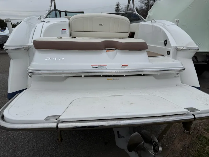 Slide: The Image of 2013 Cobalt 242 boat with swim platform and seating, viewed from the rear. - 5