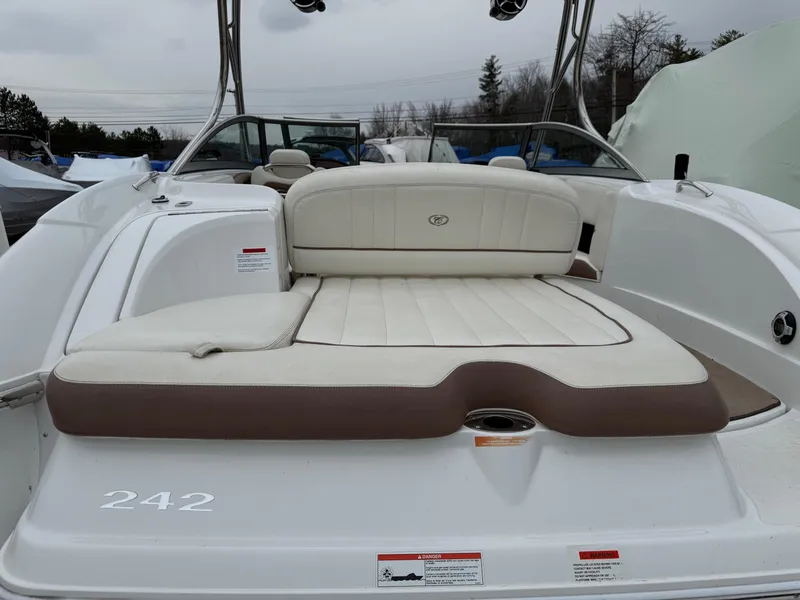 Slide: The Image of 2013 Cobalt 242 boat with white and brown seating, rear view. - 6
