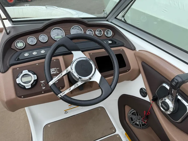 Slide: The Image of Dashboard of a 2013 Cobalt 242 boat with steering wheel and control panel. - 9