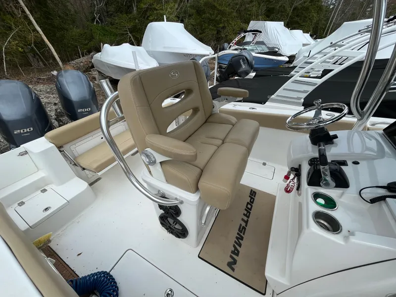 Slide: The Image of 2017 Sportsman 252 boat interior with beige seating and dual outboard motors. - 14