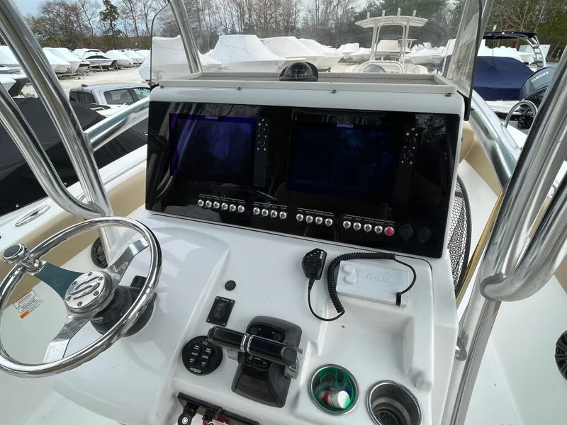 Slide: The Image of Control panel of a 2017 Sportsman 252 boat with steering wheel and navigation screens. - 18